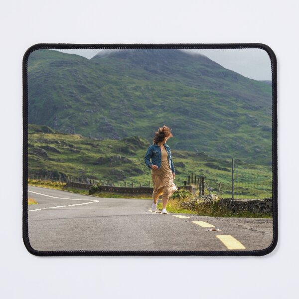 Item preview, A happy young woman wearing a dress and a blue denim jacket running along a road in Killarney National Park, Ring of Kerry, near the town of Killarney in County Kerry, Ireland. designed and sold by AlbertMi.