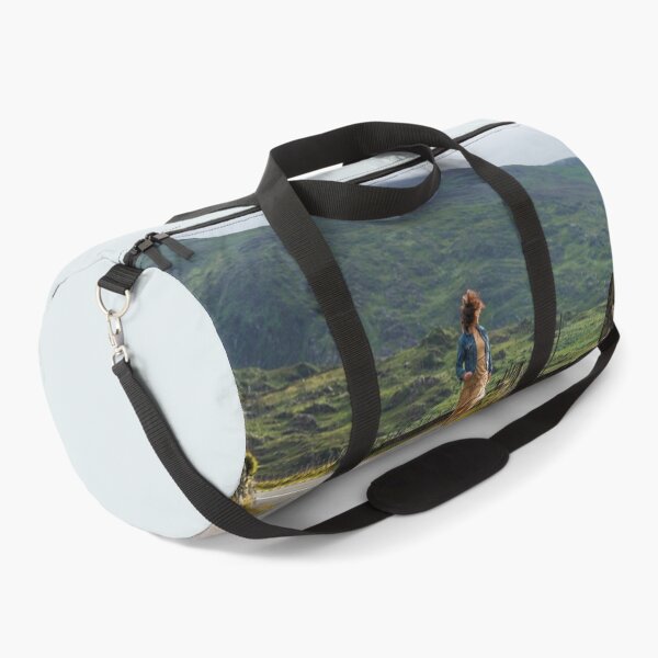 Item preview, A happy young woman wearing a dress and a blue denim jacket running along a road in Killarney National Park, Ring of Kerry, near the town of Killarney in County Kerry, Ireland. designed and sold by AlbertMi.