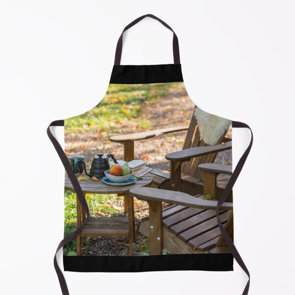 Item preview, An open book, a kettle with a cup of tea, a plate with apples and pears, on a wooden table with comfortable armchair beside, outdoor in autumn. designed and sold by AlbertMi.