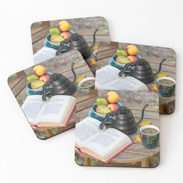 Item preview, An open book, a kettle with a cup of tea, a plate with apples and pears, on a wooden table with comfortable armchair beside, outdoor in autumn. designed and sold by AlbertMi.