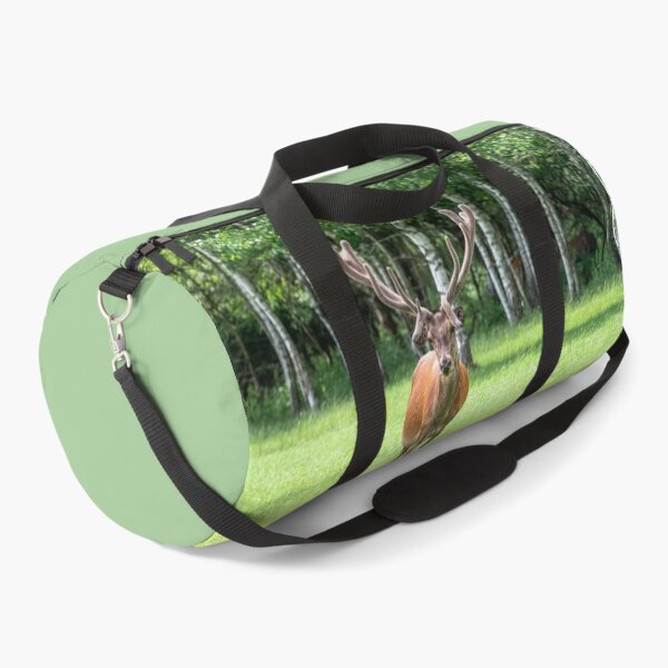 Item preview, A majestic red deer grazing in a meadow in summer designed and sold by AlbertMi.