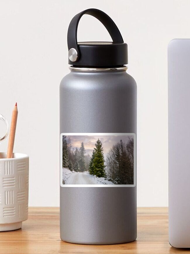 Thumbnail 1 of 3, Sticker, road through snowy forest on foggy morning designed and sold by mike-pellinni.