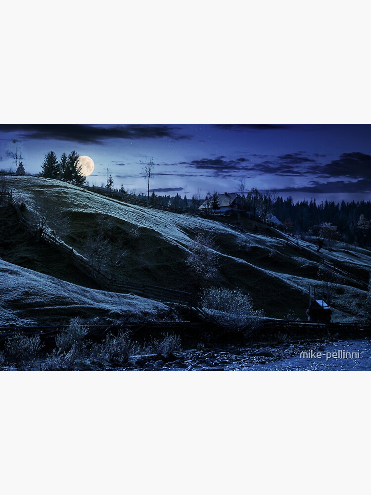 Thumbnail 3 of 3, Sticker, grassy rural hillside near the village at night designed and sold by mike-pellinni.