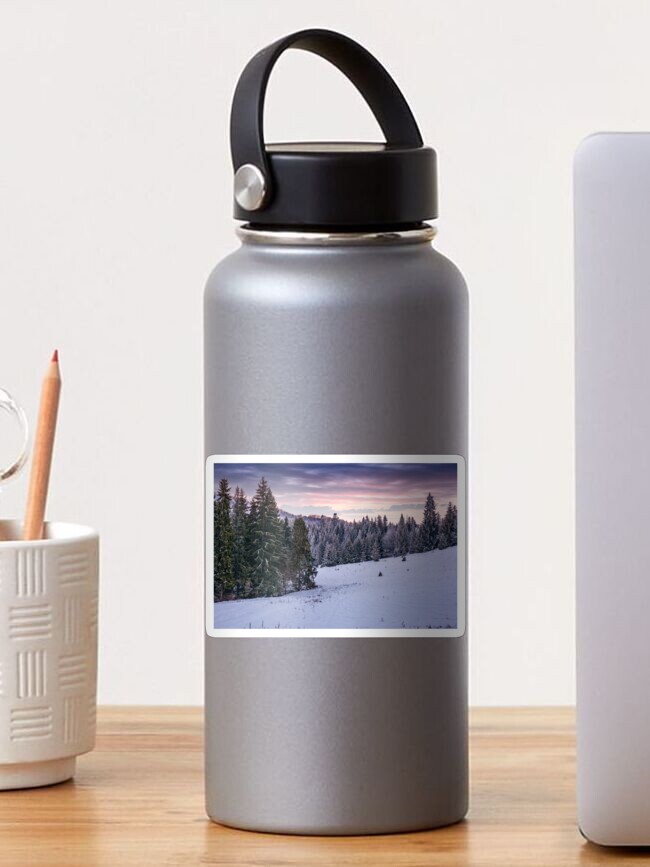 Thumbnail 1 of 3, Sticker, spruce forest on a snowy hillside at dusk designed and sold by mike-pellinni.