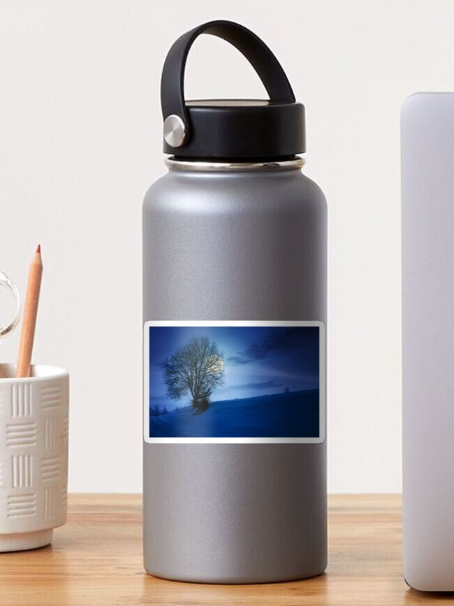 Thumbnail 1 of 3, Sticker, leafless tree on snowy slope at night designed and sold by mike-pellinni.
