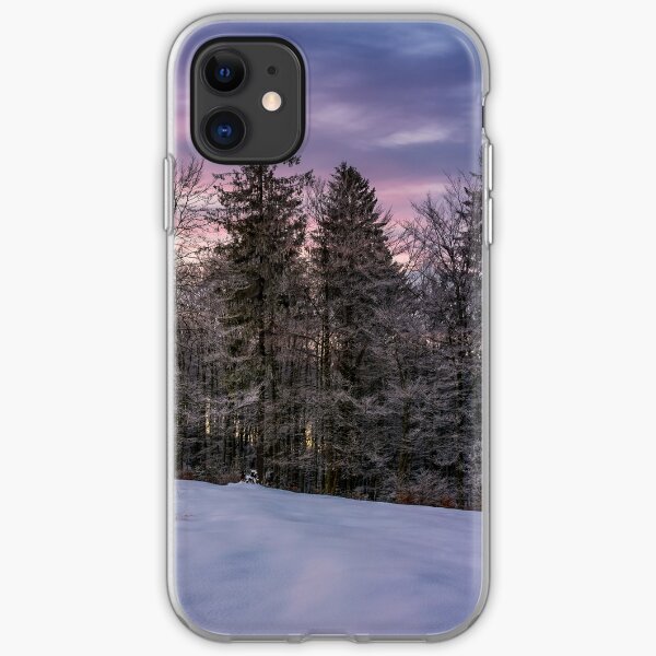 forest in hoarfrost on snowy hillside at dawn iPhone Soft Case