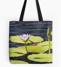 Lily Pad in Flower on Rippling Pond. Tote Bag
