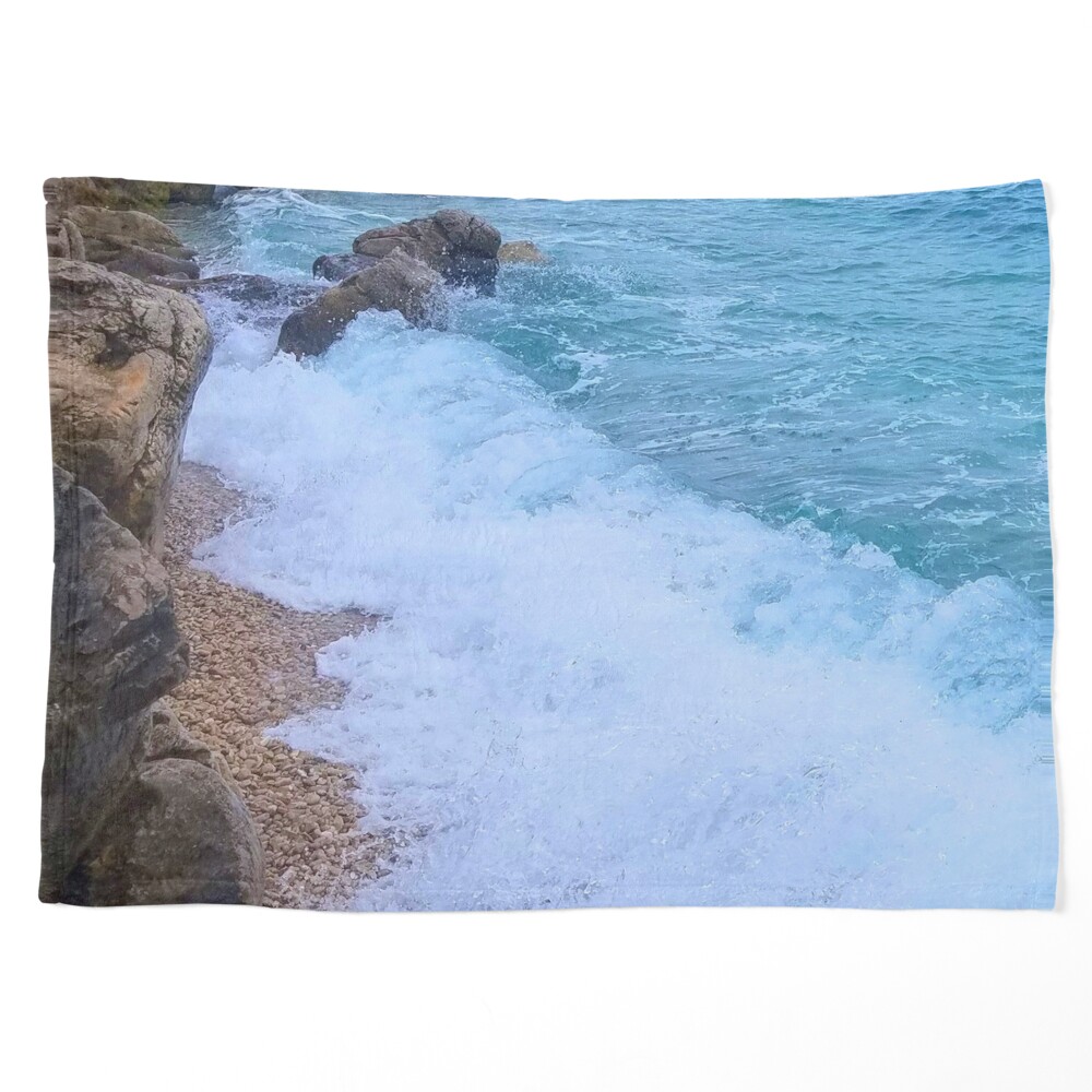 Blue Ocean Waves Against The Rocks