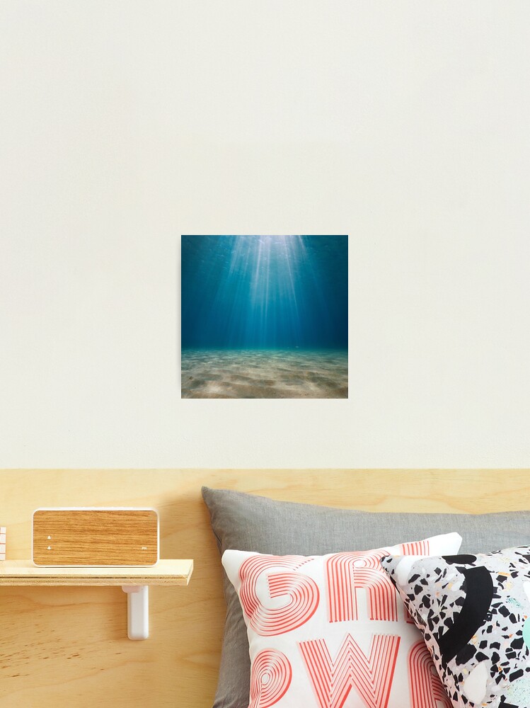 Rays of sunlight underwater with sandy seabed Mediterranean sea