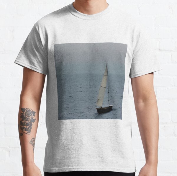 A lonely sail turns white in the blue mist of the sea! Waves play - the wind whistles, and the masts bend and creak Classic T-Shirt