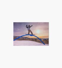 Snowboarder sliding on a rail Art Board