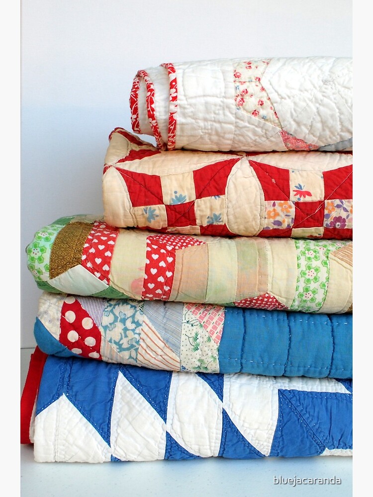 Stack of vintage patchwork quilts by bluejacaranda