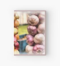 Decorative onions hanging on a string on a farmers market Hardcover Journal