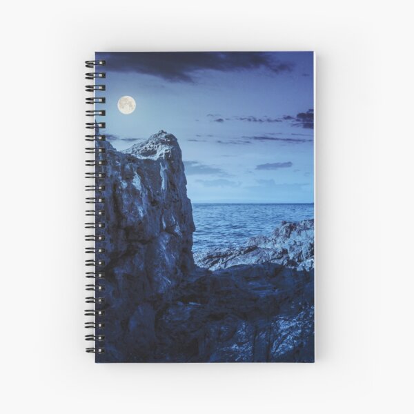 sea bay with boulders and old city at night Spiral Notebook