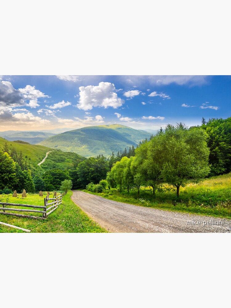 Thumbnail 3 of 3, Sticker, fence near road down the hill with forest in mountains at sunrise designed and sold by mike-pellinni.