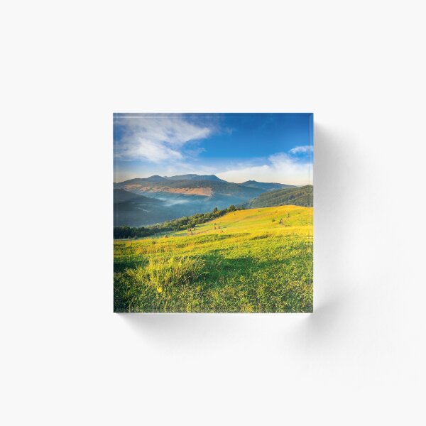 haystacks in agricultural field in mountain Acrylic Block