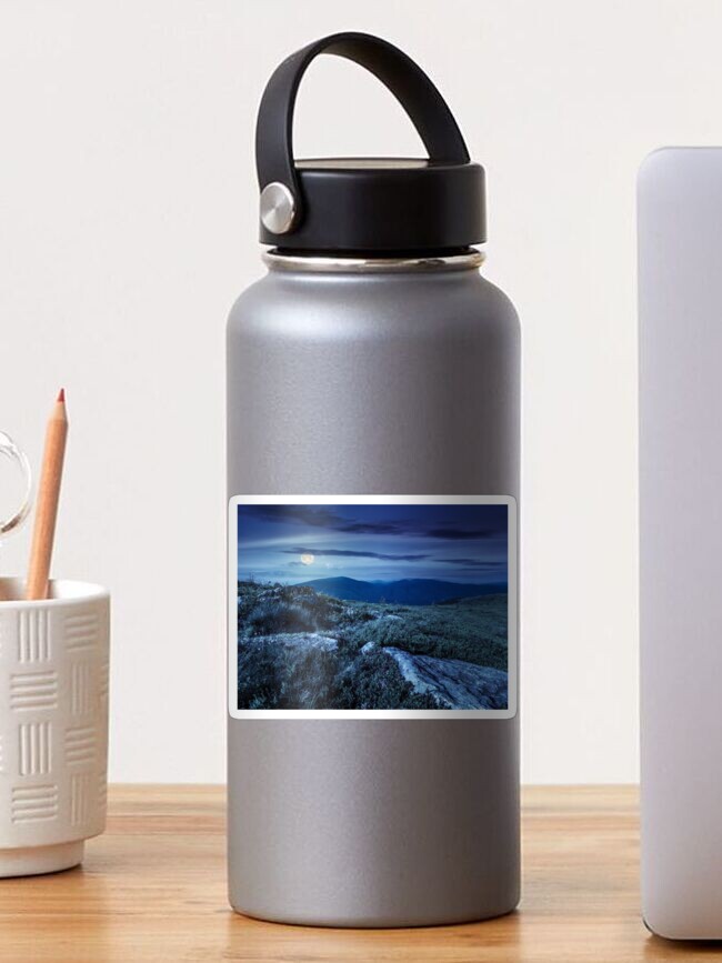 Thumbnail 1 of 3, Sticker, stones in valley on top of mountain range at night designed and sold by mike-pellinni.