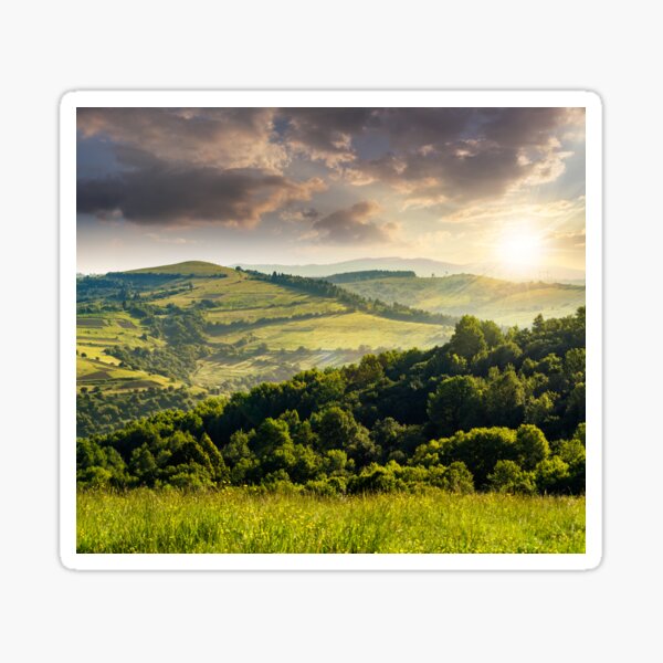 agricultural fields in mountains at sunset Sticker