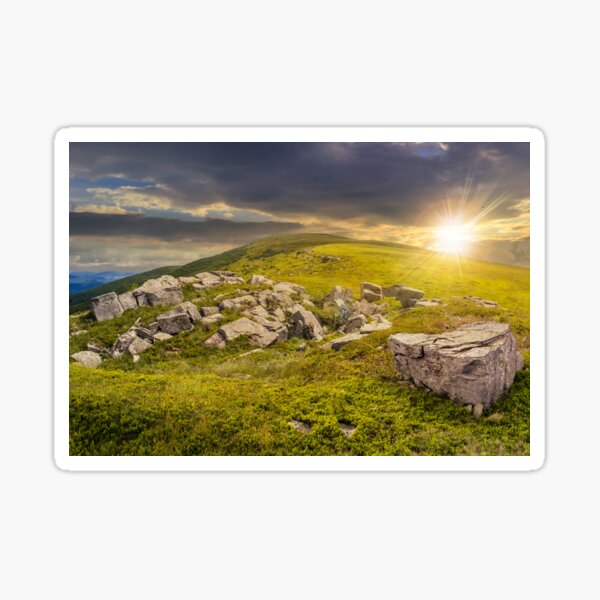 white boulders on the hillside at sunset Sticker