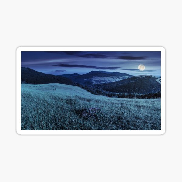 valley in mountains on hillside under sky with clouds at night Sticker