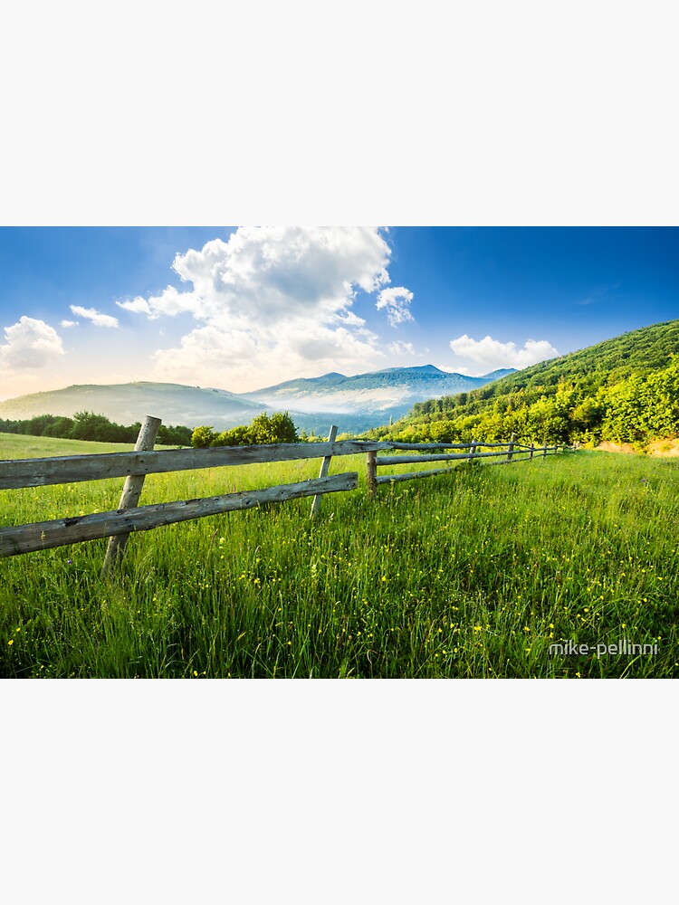 Thumbnail 3 of 3, Sticker, fence on hillside meadow in mountains at sunrise designed and sold by mike-pellinni.