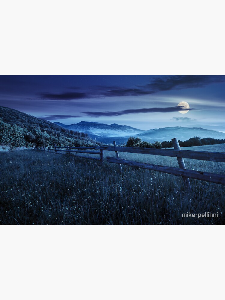 Thumbnail 3 of 3, Sticker, fence on hillside meadow in mountains at night designed and sold by mike-pellinni.