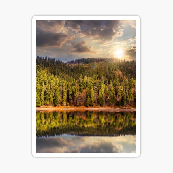 lake near the mountain in pine forest at sunset Sticker
