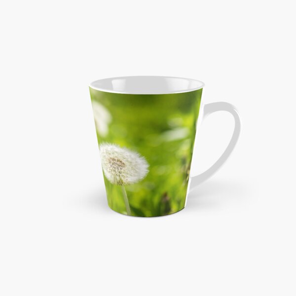 white dandelion on green grass blur background Tall Mug