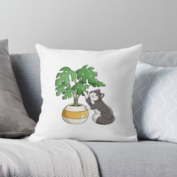 Katze spielt mit Monstera-Blatt Dekokissen
