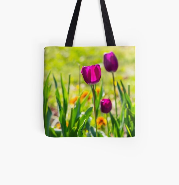 purple tulip on blurred background of grass All Over Print Tote Bag