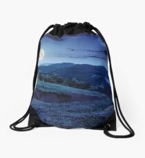 flowers on hillside meadow in mountain at night Drawstring Bag