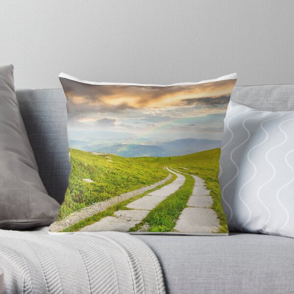 road on a hillside near mountain peak Throw Pillow