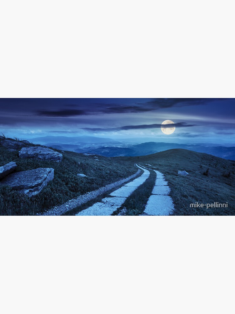 road on a hillside near mountain peak at night by mike-pellinni
