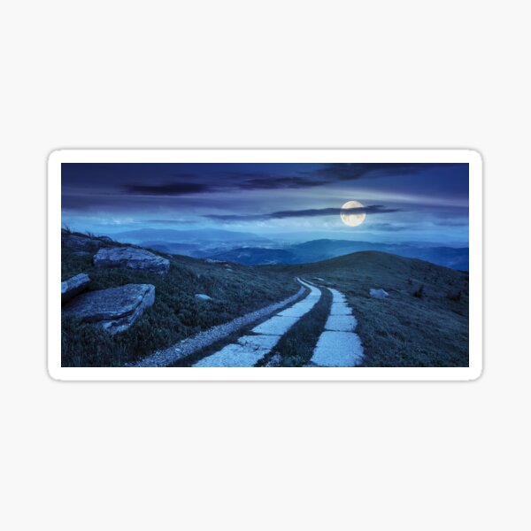 road on a hillside near mountain peak at night Sticker