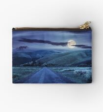 abandoned road through meadows in mountain at night Studio Pouch