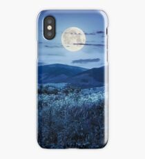 meadow with flowers in mountains at night iPhone Case