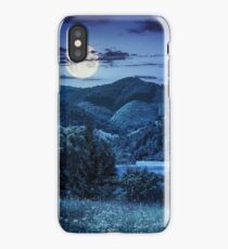 pine trees near meadow in mountains at night iPhone Case
