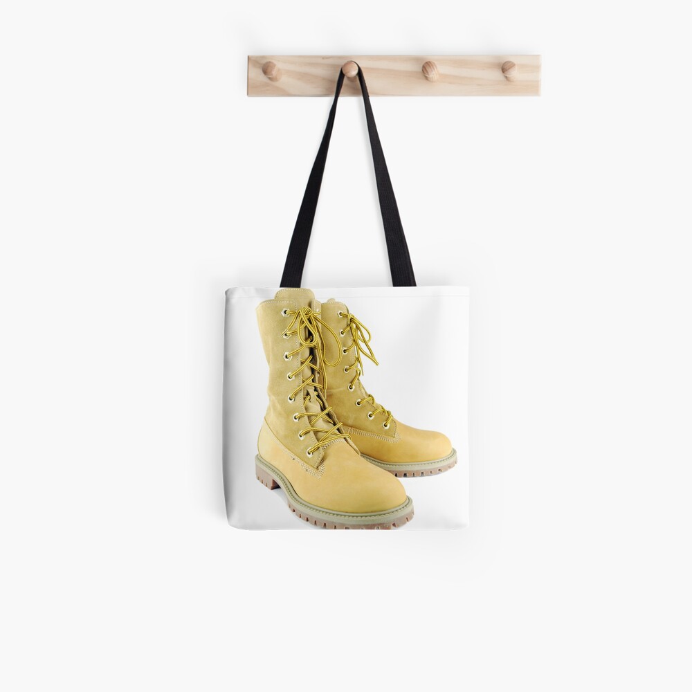 Yellow tall hiking boots on white\