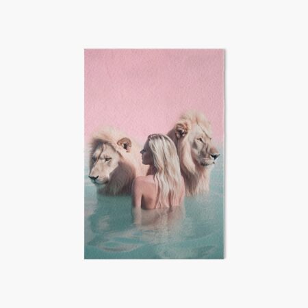 Woman swimming with lions Art Board Print