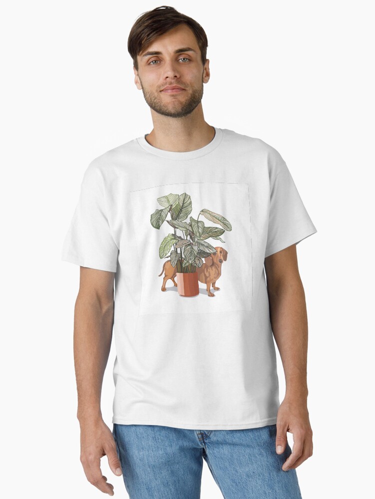 Thumbnail 1 of 7, Classic T-Shirt, Dachshund sausage dog with house plant designed and sold by rosalindjelbert.