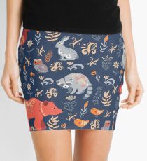 Fairy-tale forest. Fox, bear, raccoon, owls, rabbits, flowers and herbs on a blue background. Mini Skirt