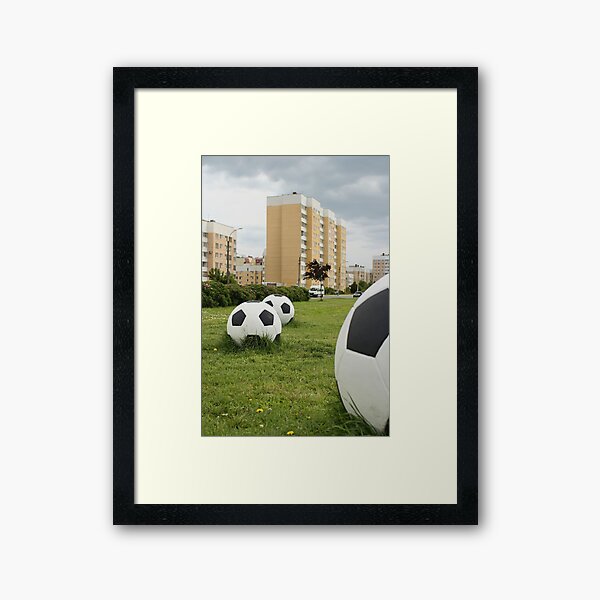 soccer balls on the cityscape Framed Art Print