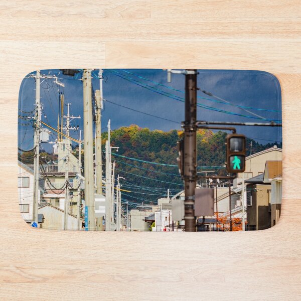 Item preview, Illuminated hilltop with dark clouds through a city street designed and sold by Shizenkai.