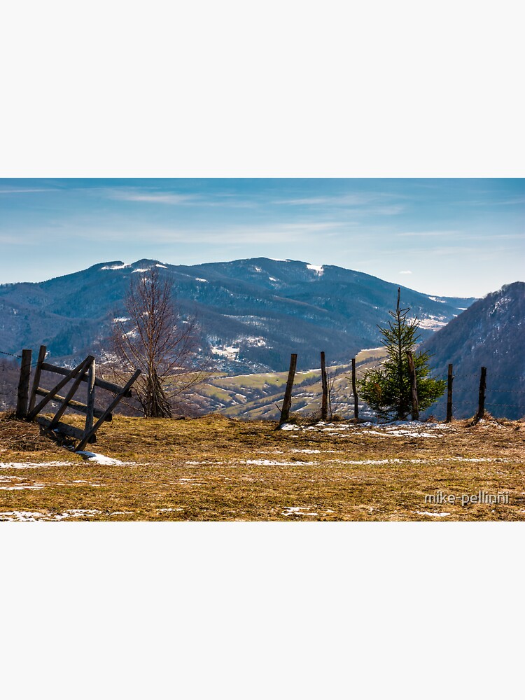 wooden fence on the edge of a hillside by mike-pellinni