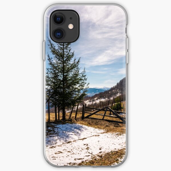 spruce trees near the fence on hillside iPhone Soft Case