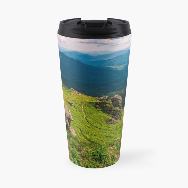 footpath among huge rocks on the edge of a hill Travel Mug