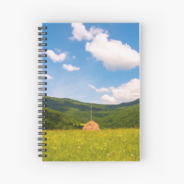 haystack on a grassy pasture in mountains Spiral Notebook