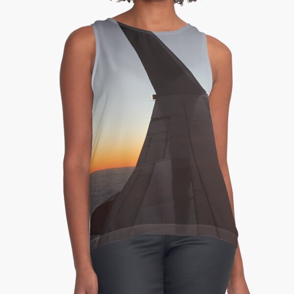 The setting sun, evening dawn, pink clouds from the side of the plane. Sleeveless Top