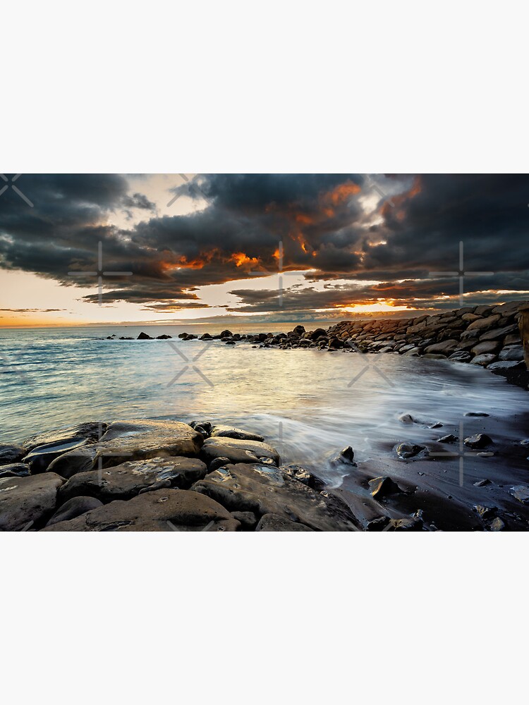 Seascape at sunset over rocks at Calheta, Madeira