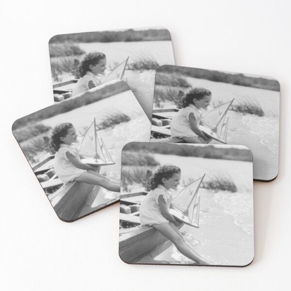 Item preview, Young girl at seashore holding sailboat, summer. designed and sold by ScienceSource.